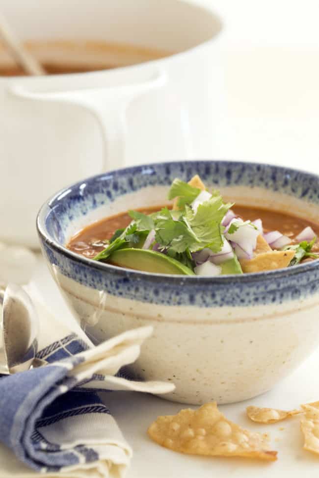 This easy taco soup combines  ground turkey, refried beans, tomatoes and tortillas and simmers it all in a deliciously rich broth seasoned with classic Mexican flavors