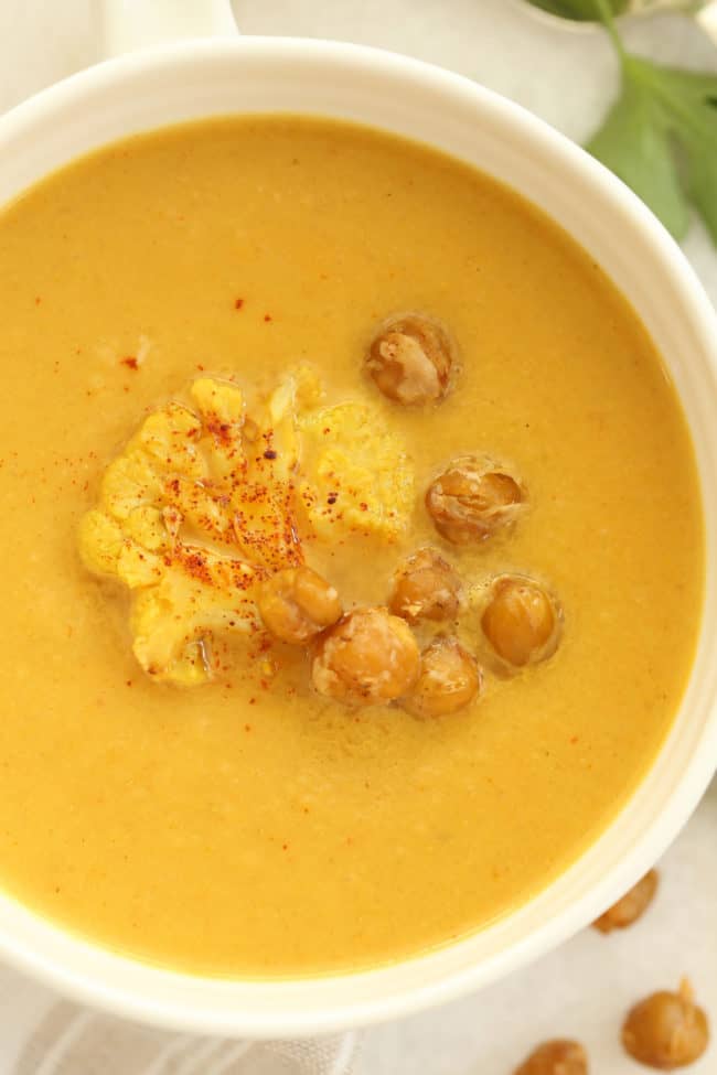This Curried Roasted Cauliflower Soup is  made with roasted cauliflower, onion, garlic, coconut milk and seasoned with delicious curry