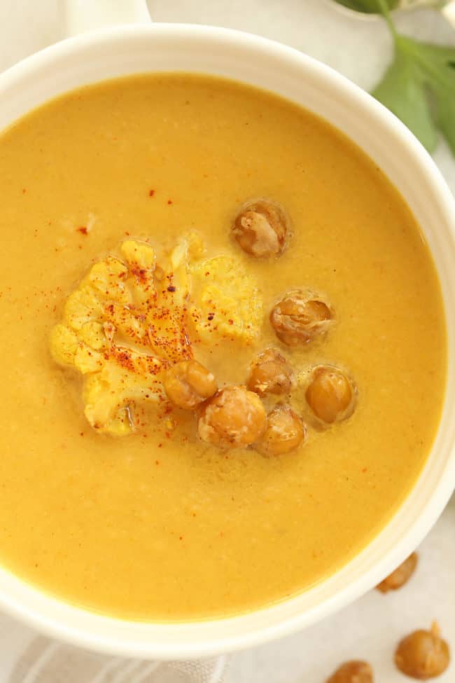 A large white bowl filled with a creamy pureed vegetable broth.