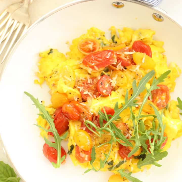 These Tomato Basil Scrambled Eggs are made with eggs, basil, cherry tomatoes and parmesan cheese