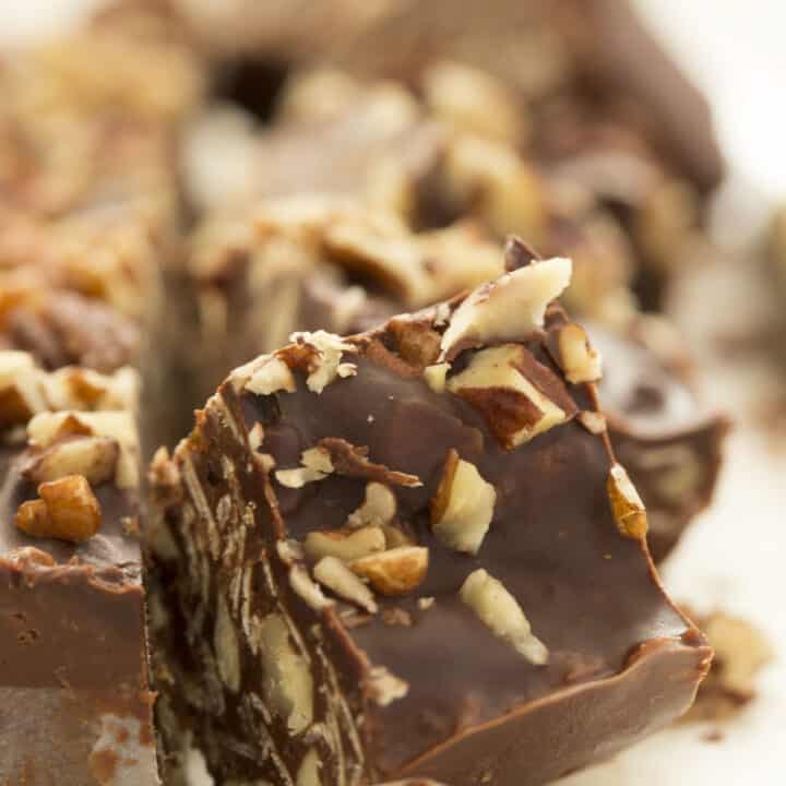 Chocolate oat squares on pieces of white candy paper.