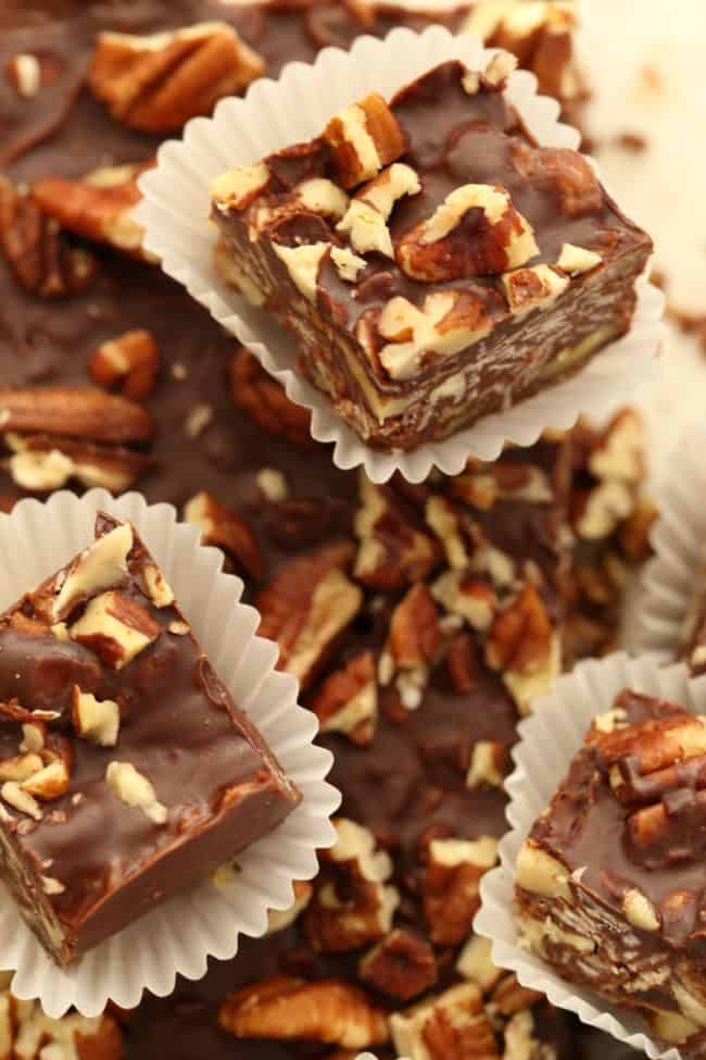 Chocolate oat squares in pieces of white candy paper