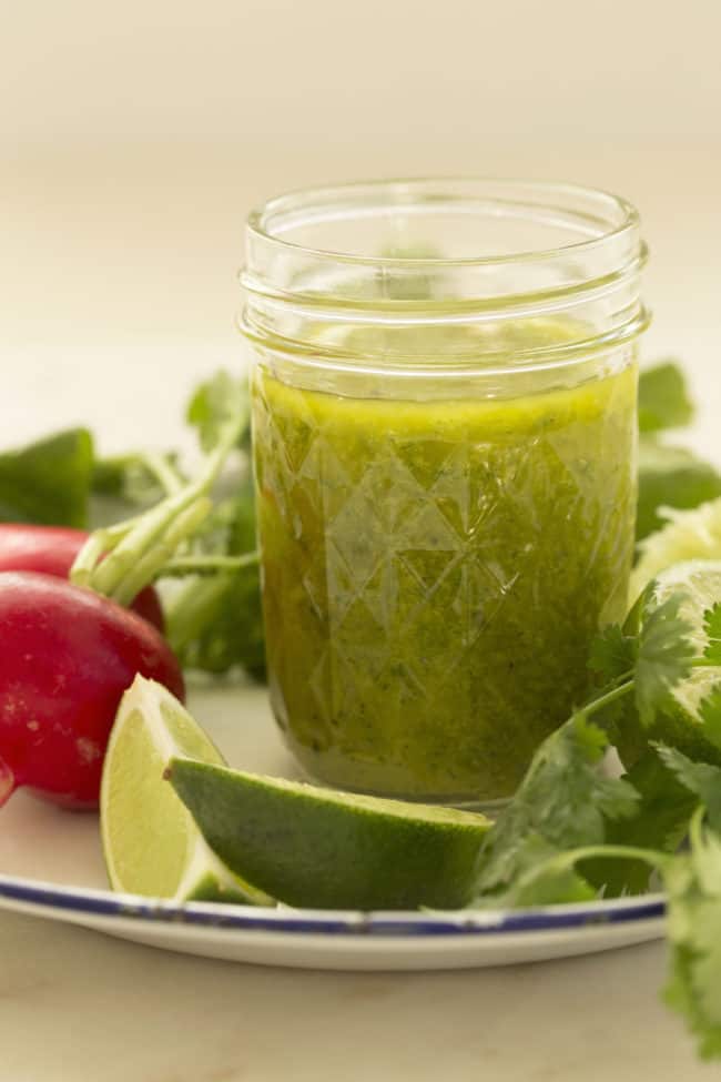 glass jar filled with cilantro lime vinaigrette