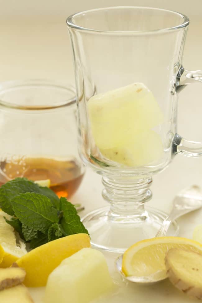 A glass filled with ginger ice cubes.