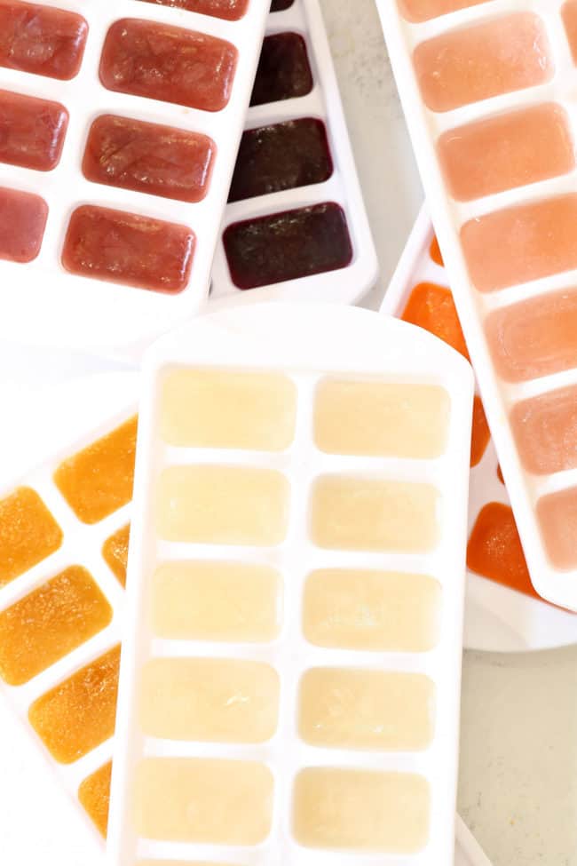 ice cube trays filled with fruit juice ice cubes