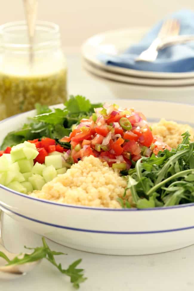 This Mexican Quinoa Salad is a powerhouse salad packed with quinoa, cucumber, arugula, red pepper, pico de gallo, toasted nuts and lots of fresh cilantro