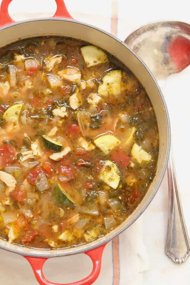 A large red pot filled with chicken tortilla soup