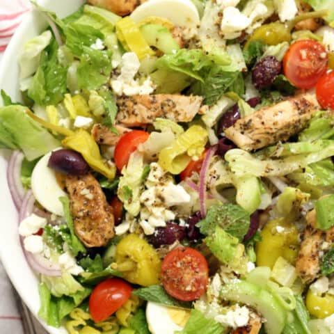 This Greek Chopped Salad is loaded a variety of fresh organic vegetables, marinated grilled chicken, hardboiled eggs and it's all tossed in a delicious Greek salad dressing