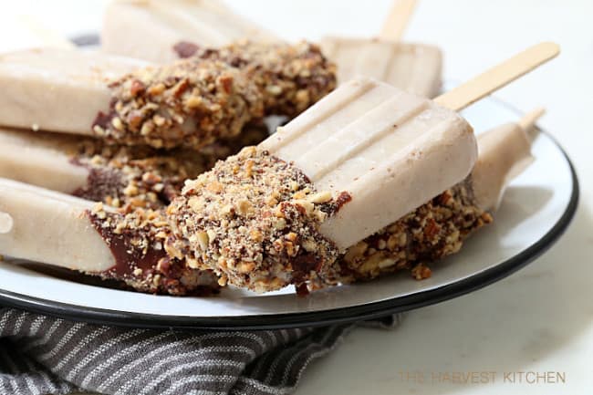 These Almond Milk Popsicle are made with almond milk, almond butter, bananas and Greek yogurt, then dipped in chocolate sauce and rolled in toasted almonds