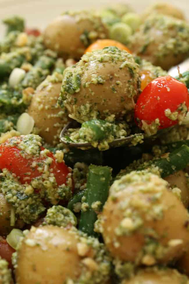 This Arugula Pesto Potato Salad is made of tender baby potatoes are mixed with green beans and heirloom cherry tomatoes, then it's all tossed in a delicious nutty arugula pesto