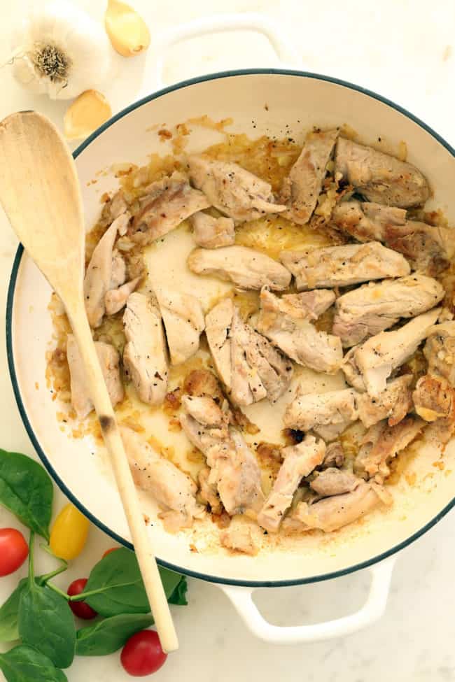 A white pan filled with cooked poultry.