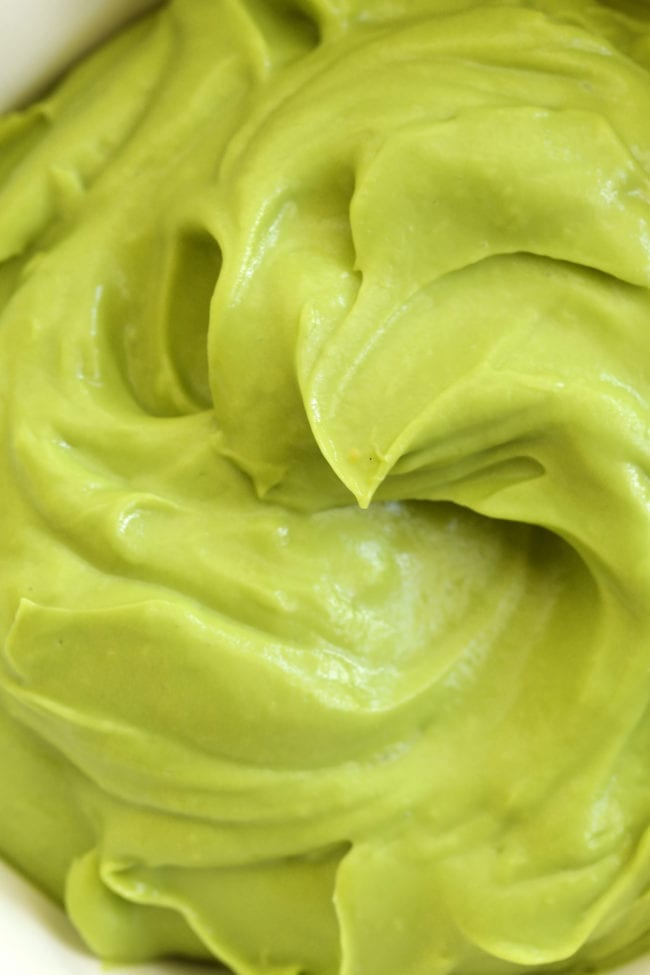 A white bowl of avocado mayo.