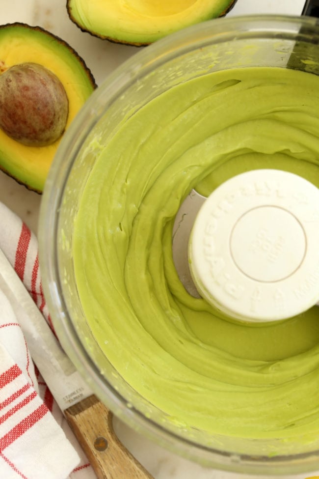 A food processor filled with avocado spread.