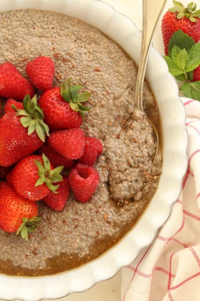 A white baking dish filled with overnight chia seed pudding. A spoon is resting in the dish.