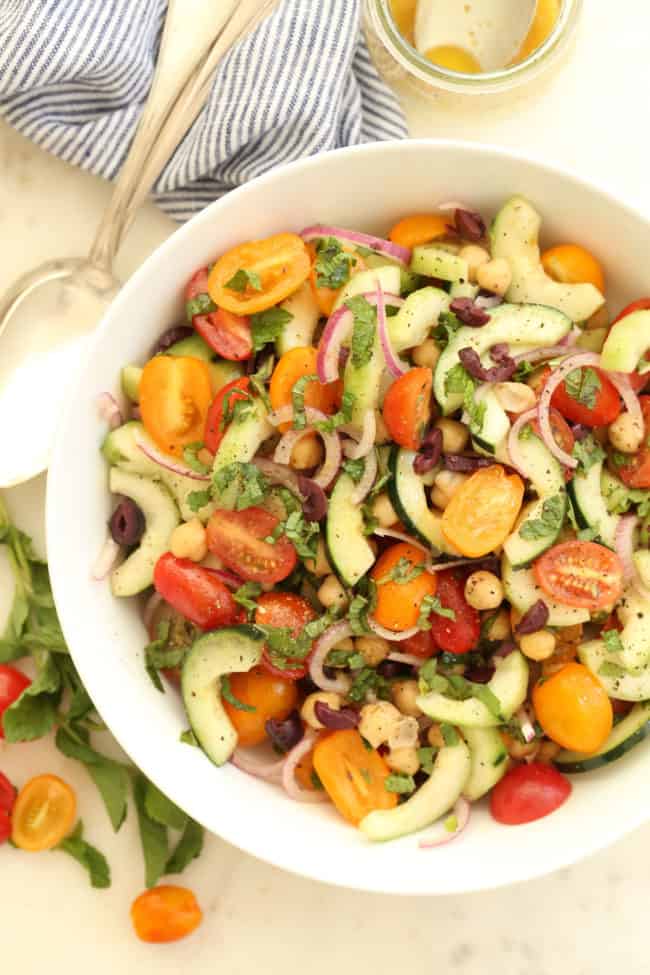 This Mediterranean Chickpea and Cucumber Salad is a fresh summery salad that's made with cucumbers, ripe juicy tomatoes, chickpeas, purple onion and fresh mint leaves