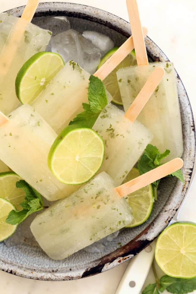 A gray dish filled with frozen ice pops.