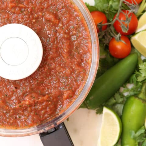 A food processor filled with restaurant style salsa.