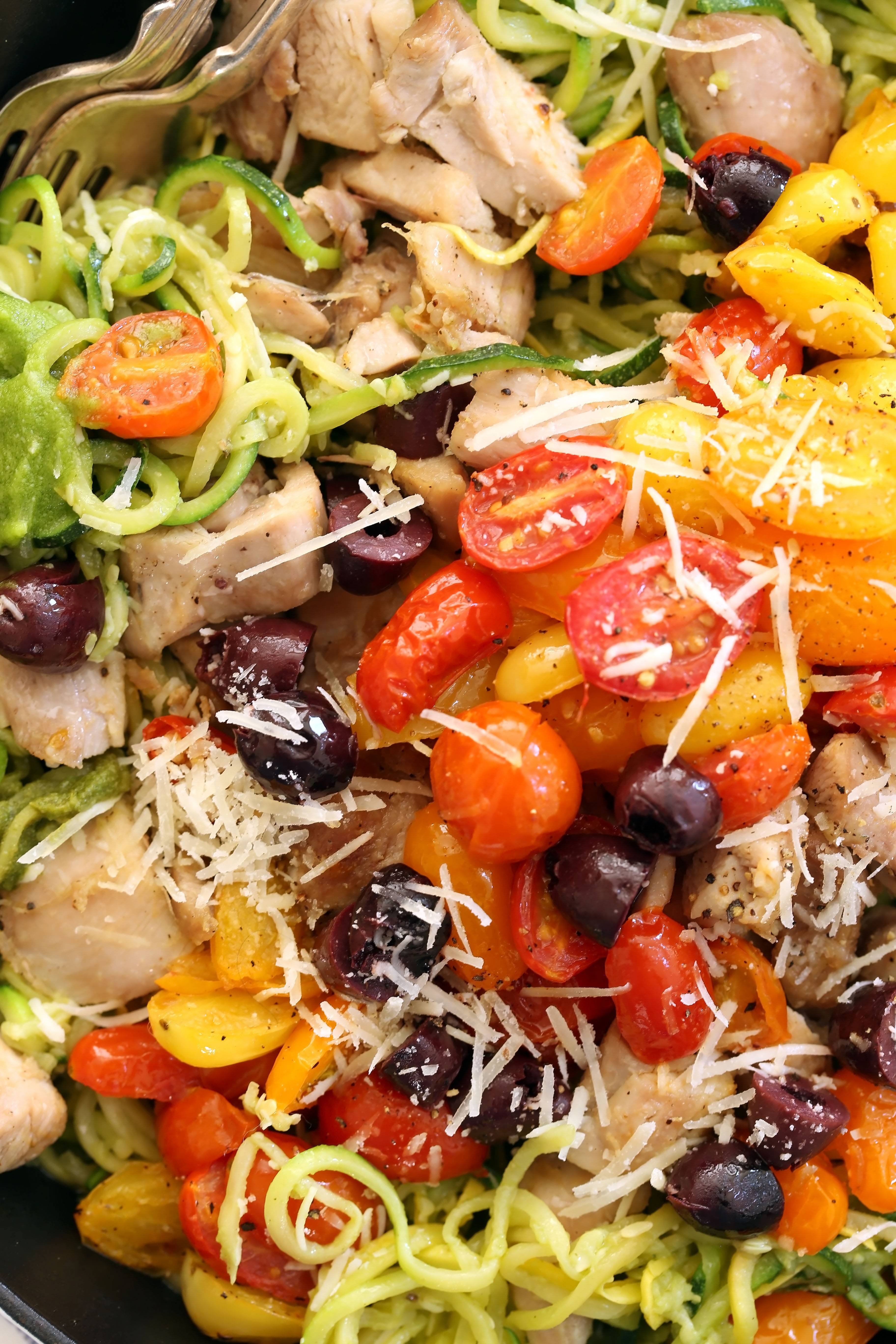 This delicious Pesto Zucchini Noodles with Chicken and pan-roasted tomatoes is a quick and easy chicken dinner you can make any night of the week