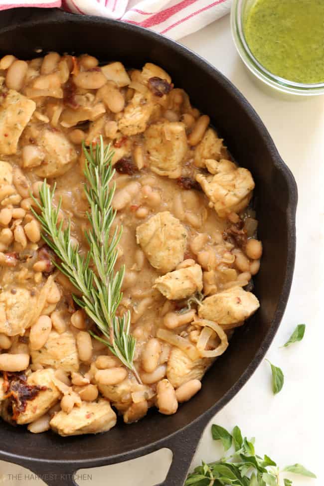 This healthy Tuscan Chicken with White Beans is an easy skillet chicken dinner recipe that comes together in about 20 minutes