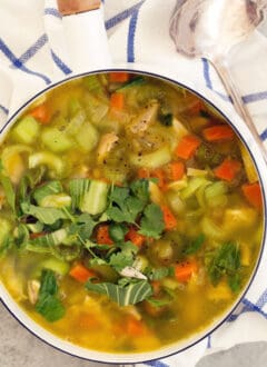 A white pot filled with Immune Boosting Chicken Soup.