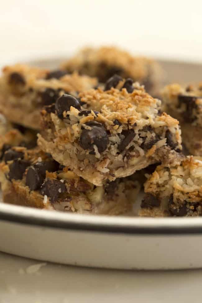 A white plate filled with gluten-free magic cookie bars