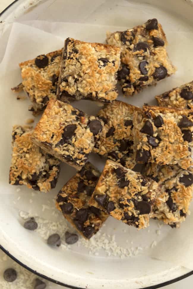 A white plate filled with chocolate chip dessert squares.