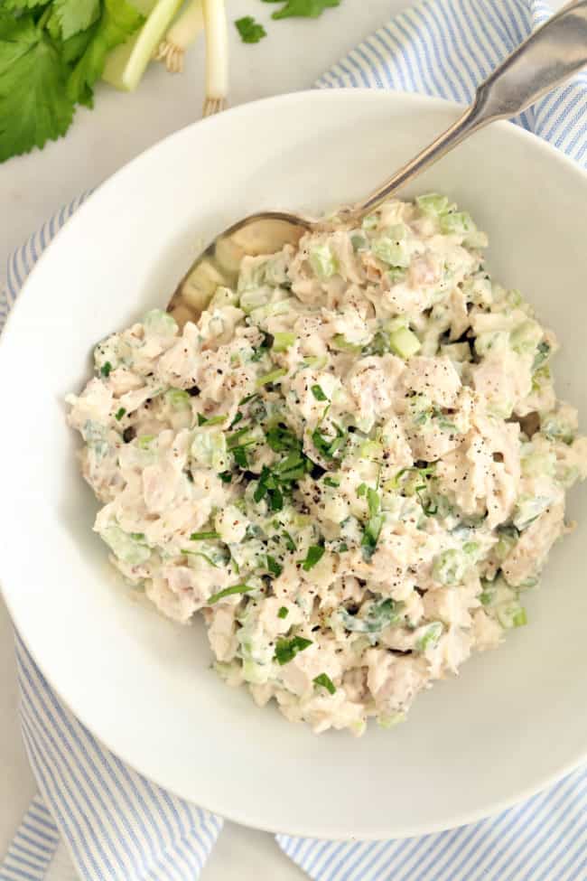 A white bowl of tarragon chicken salad.