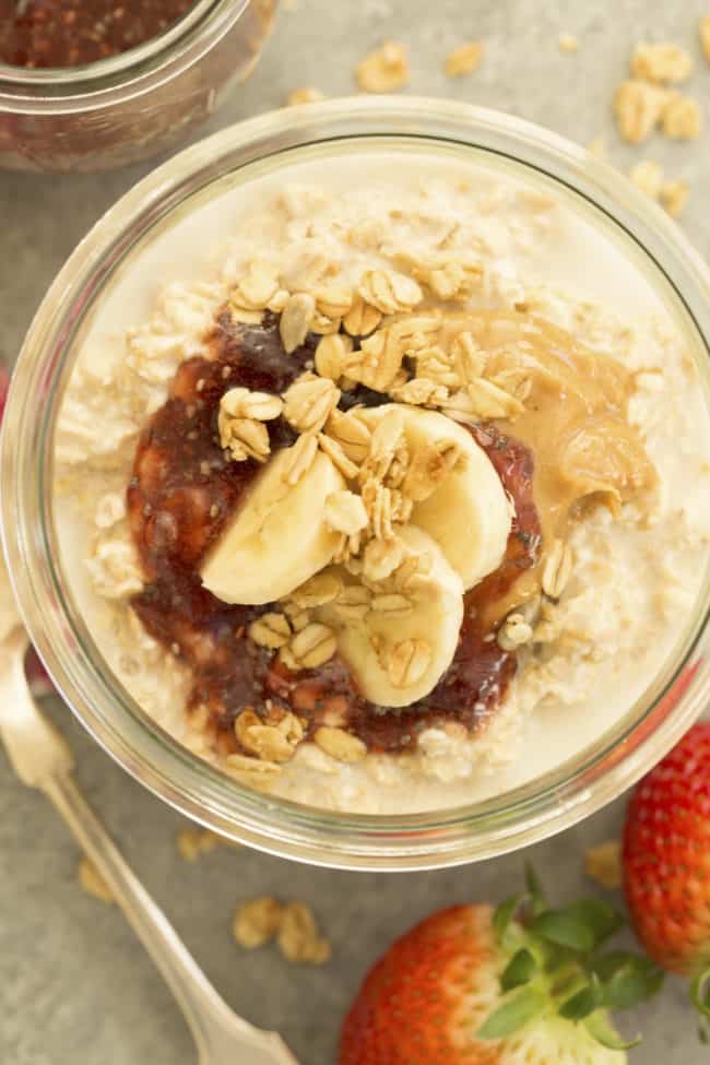 A clear jar filled with peanut butter overnight oats.