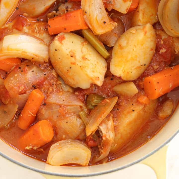 A Dutch oven filled with cooked chicken and vegetables for a stew called Chicken Continental.