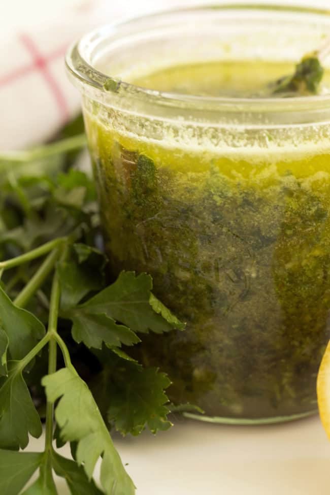 A clear glass mason jar of healthy homemade salad dressing.