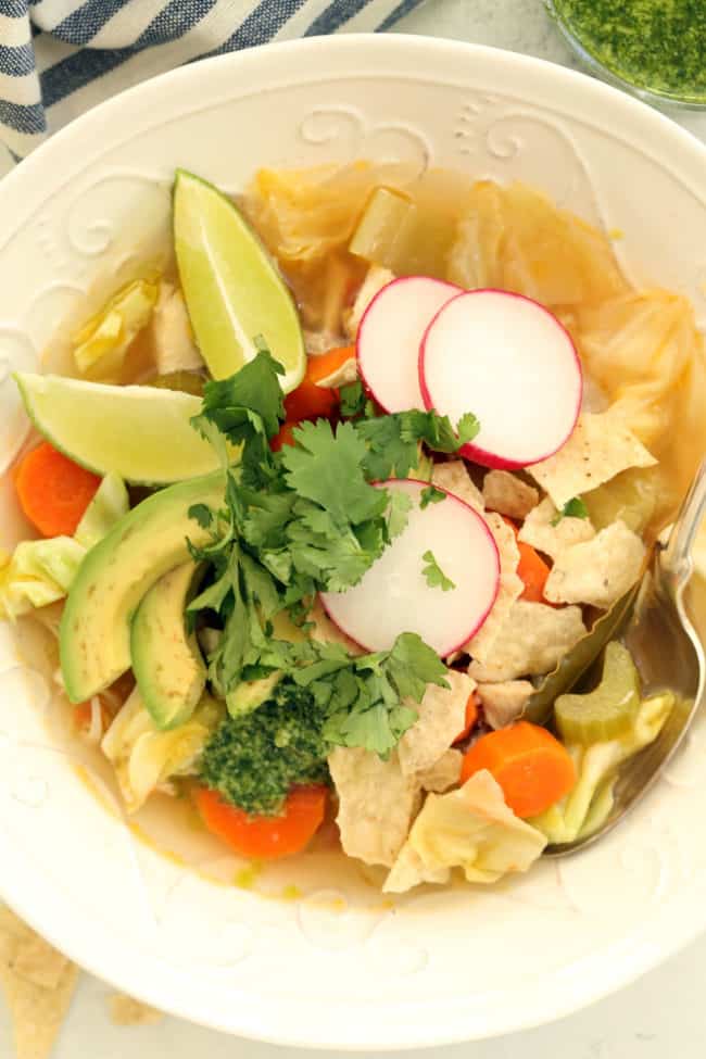 A white bowl filled with Mexican soup.