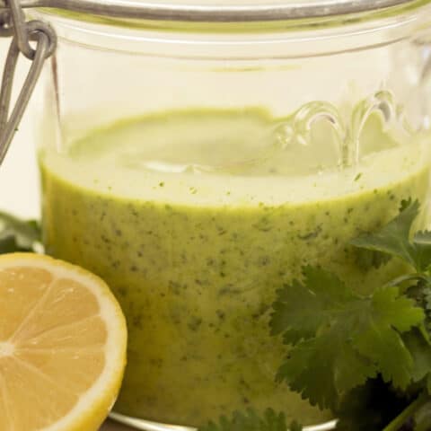 A mason jar of lemon herb vinaigrette.