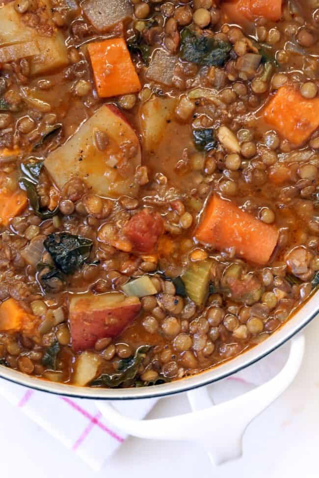 White pot filled with lentil stew.