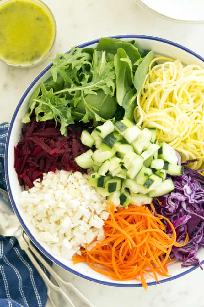 A white bowl of grated raw beets, sliced cabbage, chopped kale and grated carrots (weight loss vegetables)