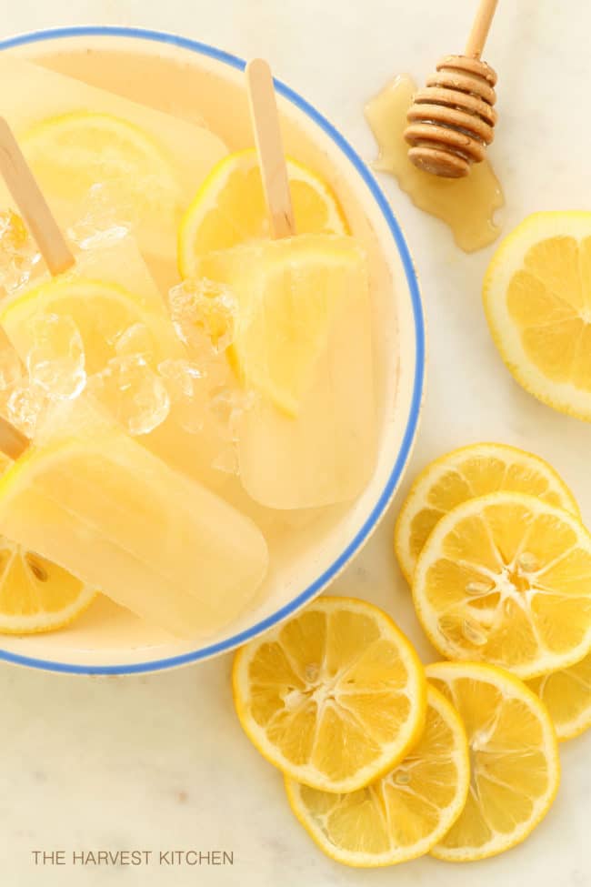A white bowl filled with lemon ginger popsciles.
