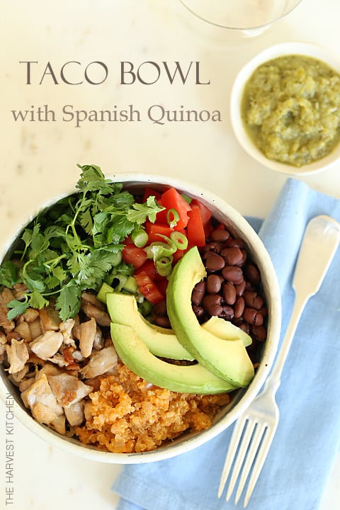 A white bowl with grilled chicken, quinoa, black beans and lettuce for taco salad bowl.
