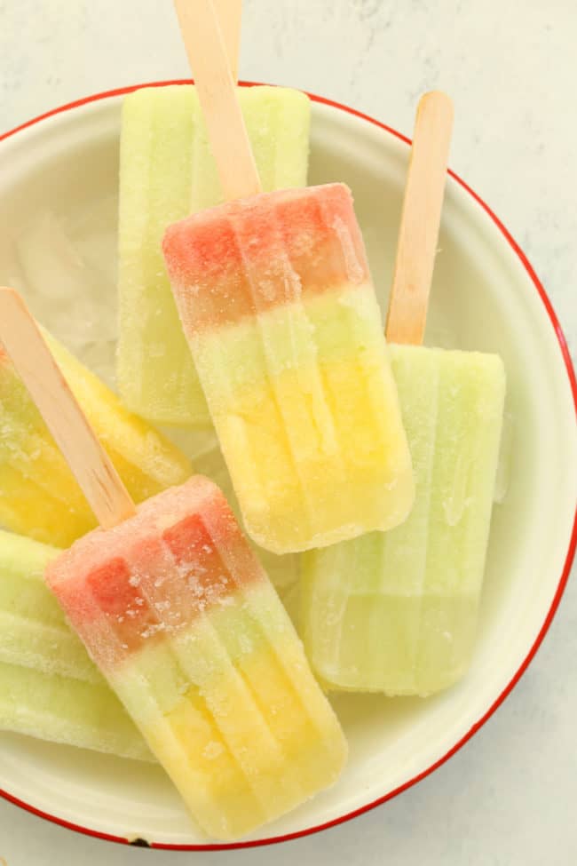 A white bowl filled with coconut water fruit popsicles.