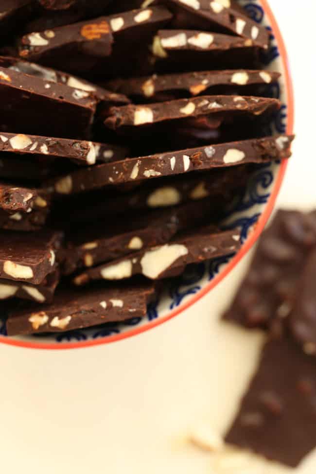 A blue and white bowl filled with dark chocolate bark.
