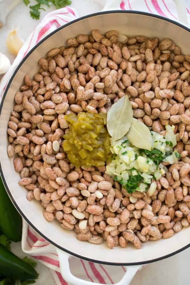 A white pot of filled with legumes