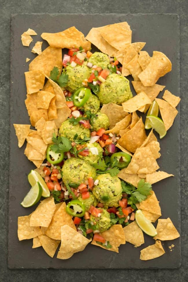 A platter filled with tortilla chops, pico de gallo and dip.