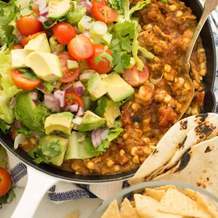 This Taco Skillet is made with ground turkey, beans, corn and salsa and makes the best turkey tacos, turkey taco bowls and turkey taco dip