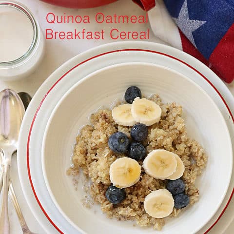 A white bowl of quinoa and oatmeal cereal with fruit.