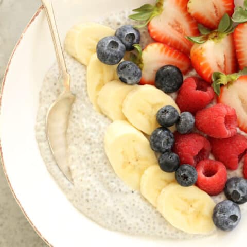 A white bowl filled with chia seed pudding and mixed fruit.