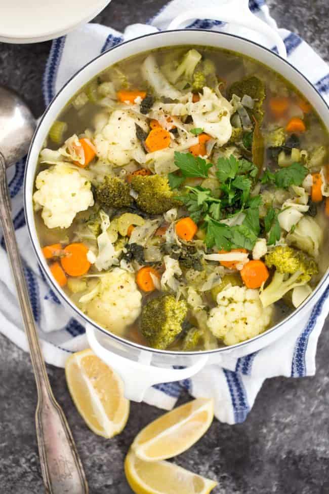 This Vegetable Soup is jam-packed with broccoli, cauliflower, cabbage, kale, carrots, celery, onion, garlic, parsley, basil and lemon