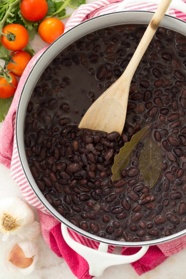 Learn how to cook black beans from scratch with dried beans, onion, garlic and bay leaves