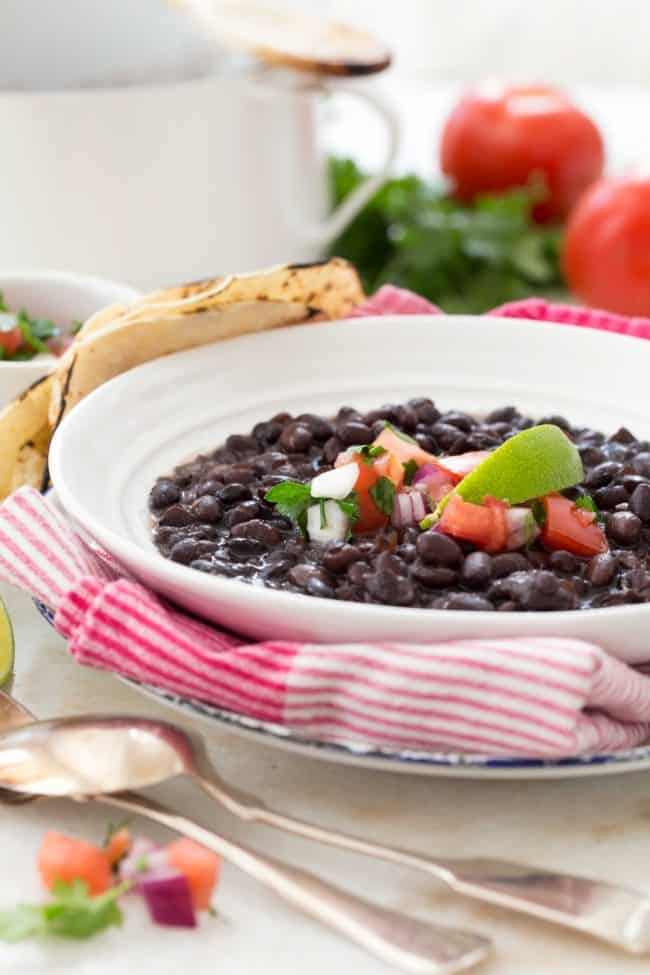 Learn how to cook black beans from scratch with dried beans, onion, garlic and bay leaves