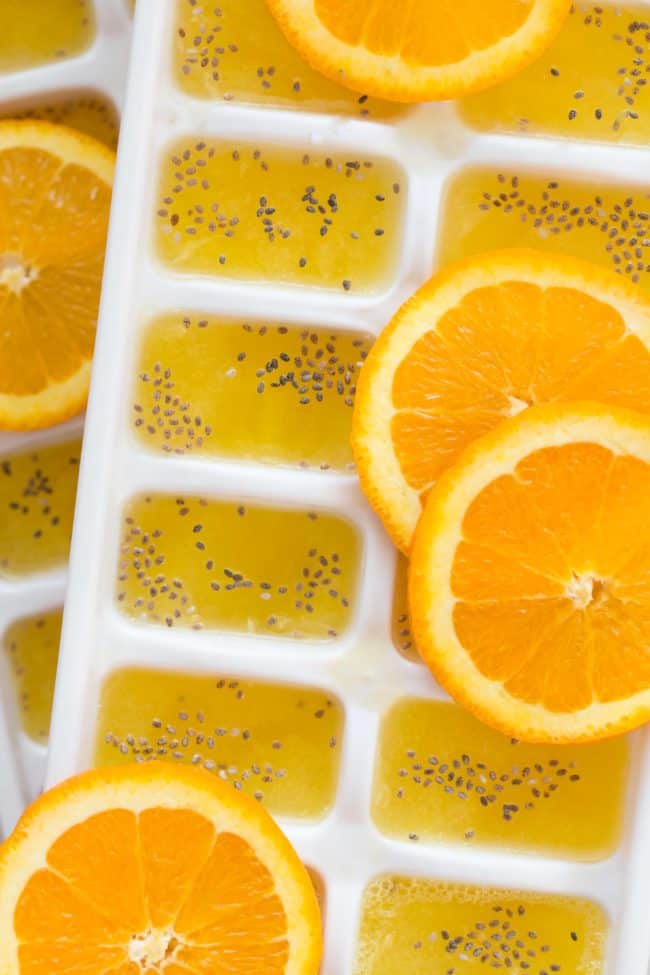 Two white ice cubes filled with frozen juice.