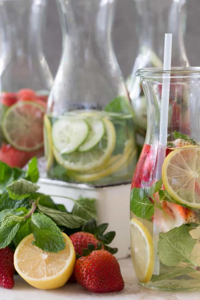 Three glasses of water with lemon slices.