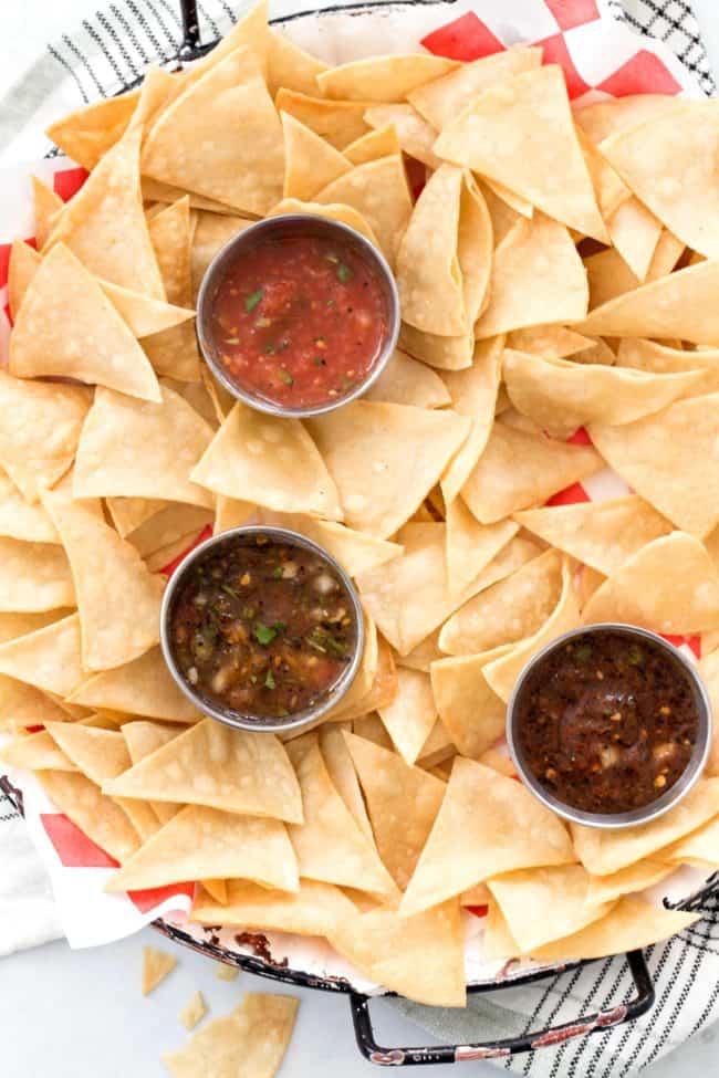 A platter of tortilla chips and salsa.