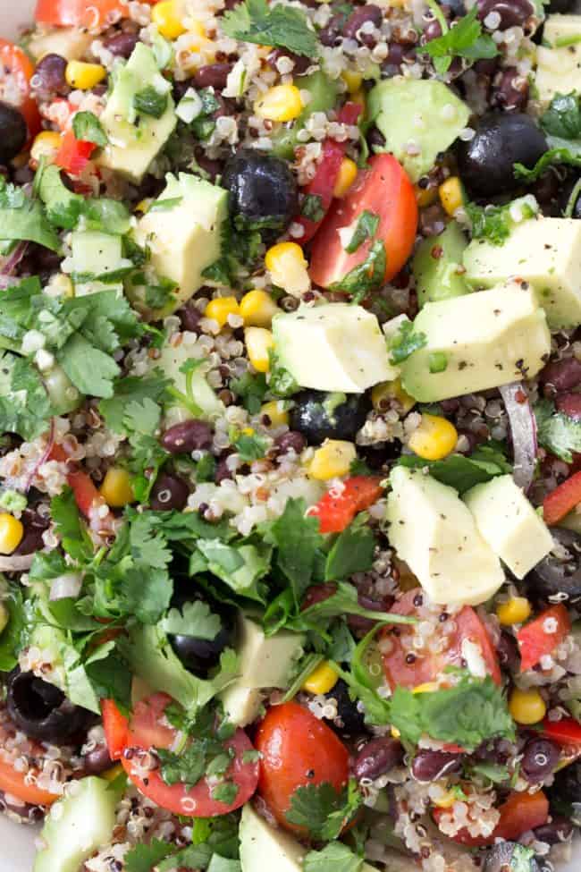 A white bowl filled with quinoa and black bean salad.